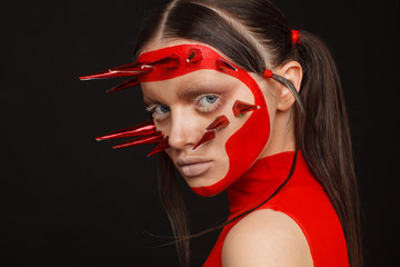 Fototapeta premium Portrait of an extraordinary model with creative makeup and hair. Black background