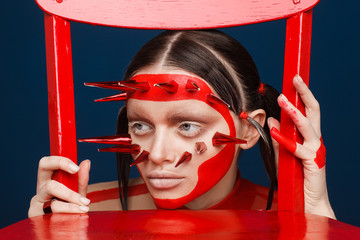 Portrait of an extraordinary model with creative makeup and hair. Studio photo session