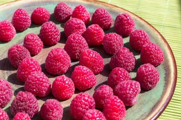Raspberry berries on a plate. Top view