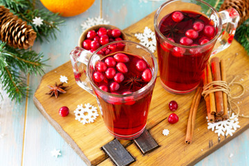 Christmas, Thanksgiving drinks. Hot winter drink with cranberries and cinnamon on wooden table. Copy space for your text.