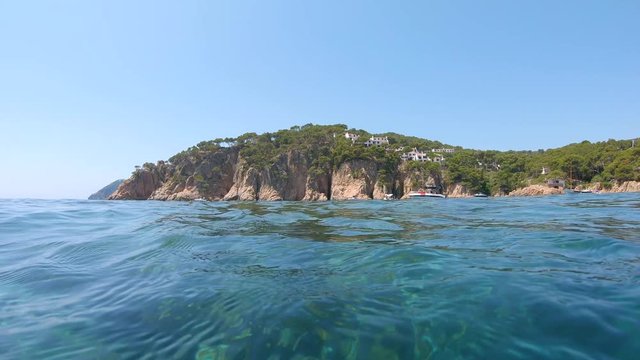 Rocky coastline seen from sea surface and move camera down underwater, Mediterranean, Spain, Costa Brava, Aigua Xelida, Palafrugell, Catalonia