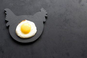 Fried eggs on a stand of slate - chicken.