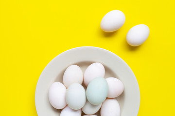 White eggs on yellow background.