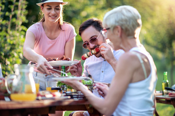 Happy family having a barbecue in summer