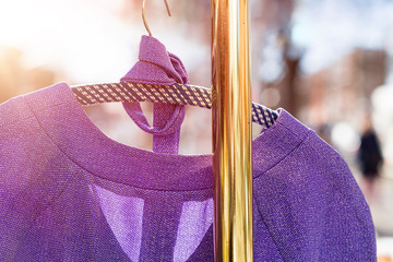 flea market, purple dress hanging on a golden clothes rack