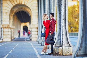 Romantic couple walking on Bir-Hakeim bridge in Paris, France