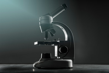 close up of a silver microscope, with black background