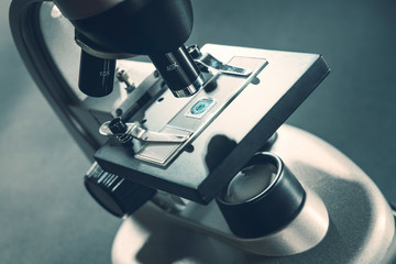 details of a silver microscope, with black background