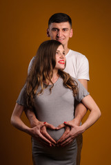 Fototapeta premium Beautiful young couple on yellow background