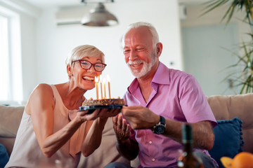 Senior couple celebrating at home