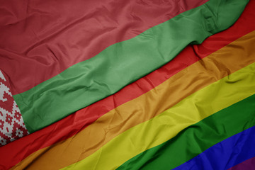 waving colorful gay rainbow flag and national flag of belarus.