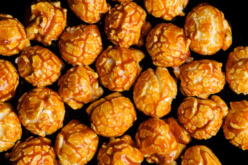 sweet Caramel Cream popcorn on the black background