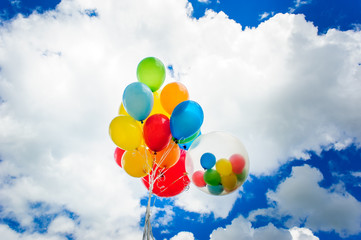 Bright colorful balloons over blue sky background