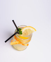 bottles of cold lemonade with lemon slices and straws