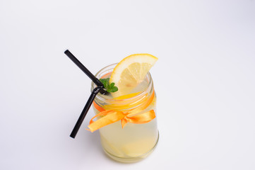 bottles of cold lemonade with lemon slices and straws