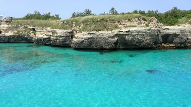 Aerial view, flight at Tower and bay of Roca Vecchia (Torre di Maradico), archaeological sites, Brindisi region, Apulia Italy