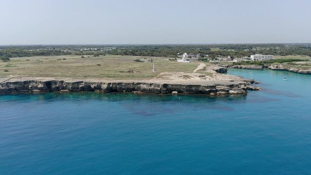 Aerial view, flight at Tower and bay of Roca Vecchia (Torre di Maradico), archaeological sites, Brindisi region, Apulia Italy
