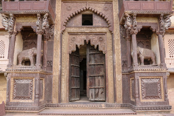 Fototapeta premium Main entrance of the Orchha Palace with wooden elephants and decorations, India