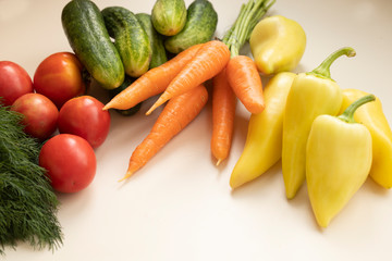 Fresh vegetables on white wood background. Mockup for menu or recipe