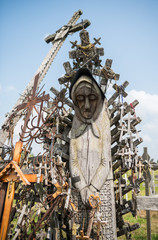 SIAULIAI, LITHUANIA - JULY 28, 2019: Old wooden sculptures on religious themes at the Hill of Crosses