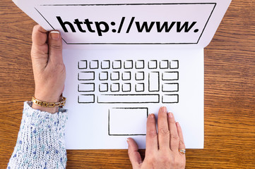 website address or URL concept. woman hands and laptop drawn on paper sheet and web address on...