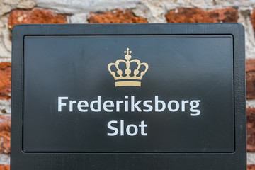 Frederiksborg castle, a danish sign and royal crown at the entrance