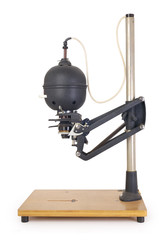 Side view of a vintage photo enlarger for projecting photo negatives, isolated on completely white background. Contains clipping path.