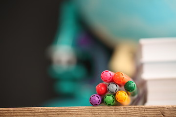 Concert education globe books microscope and pencils on background.
