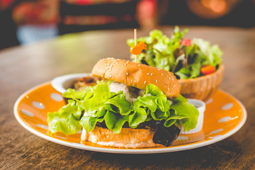 Home-made tofu burger carefully made of tofu and onion teriyaki sauce.small pan fried shredded potato and small salad and pumpkin soup