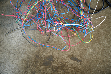 Multicolored wires twisted on the floor