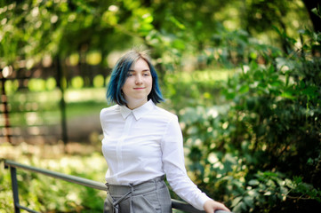Fototapeta premium teenage girl in white blouse in green summer park