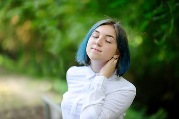 Fototapeta premium teenage girl in white blouse in green summer park