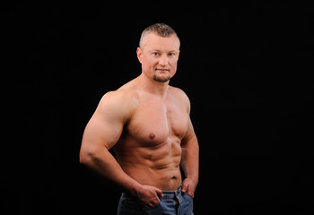 Fototapeta premium Image of muscle man posing in studio