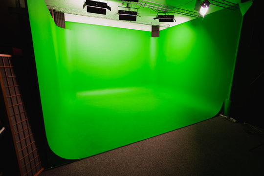 Interior of Modern Film Chroma Key Studio with Green Screen and Light Equipment