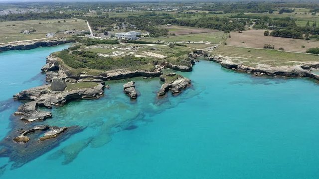 Aerial view, flight at Tower and bay of Roca Vecchia (Torre di Maradico), archaeological sites, Brindisi region, Apulia Italy