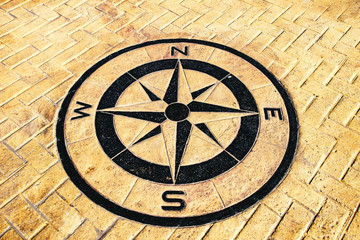 Overhead view on compass rose carved into ground