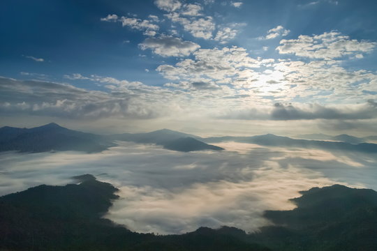 Mountain view morning of top hill around with sea of mist in valley with cloudy sky background, sunrise at Pha Tang, Chiang Rai, northern of Thailand.