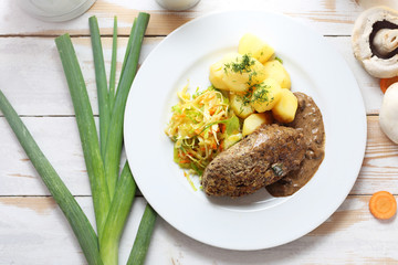 Dinner dish. Cutlet with potatoes and white cabbage salad