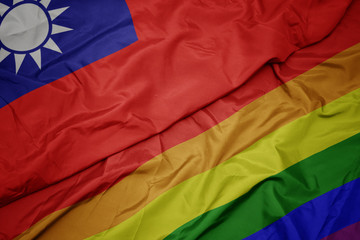 waving colorful gay rainbow flag and national flag of taiwan.