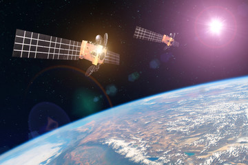 Group space satellite orbiting the earth and bright lights sun reflected from solar panels. Elements of this image furnished by NASA.