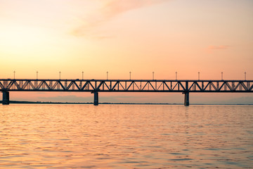 Fototapeta premium Bridge over the Amur river at sunset. Russia. Khabarovsk. Photo from the middle of the river.
