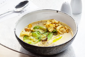 Close-up shot of a delicious cream soup with vegetables, top view.