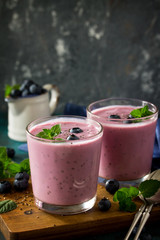 Healthy Chia seed pudding in a glass with blueberry on slate table. Healthy breakfast, vitamin snack, diet and healthy eating. Free space for your text.