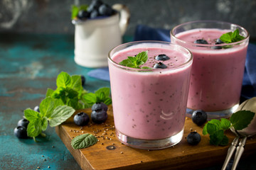 Healthy Chia seed pudding in a glass with blueberry on slate table. Healthy breakfast, vitamin snack, diet and healthy eating.
