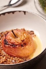 Close-up photo of a tasty baked apple stuffed with honey and nuts.