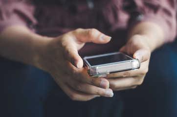hipster woman using hands touching and typing on mobile phone screen search internet online working or social communication with digital 5G technology app device in coffee shop indoor lifestyle.