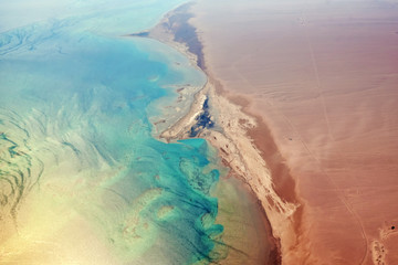 Naklejka na ściany i meble Aerial view of turquoise sea coast and a sandy beach