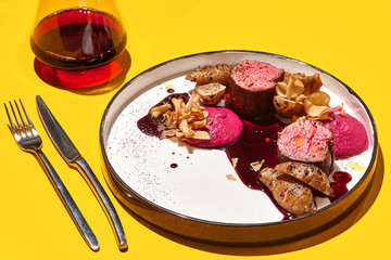 Roasted veal meat with jerusalem artichokes and sauce.