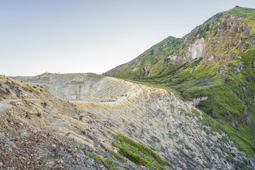 The magnificent views on green mountains from a mountain road trecking to the Ijen volcano or Kawah Ijen on the Indonesian language. Famous volcano containing the biggest in the world acid lake and