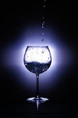 splash in glass isolated on black background